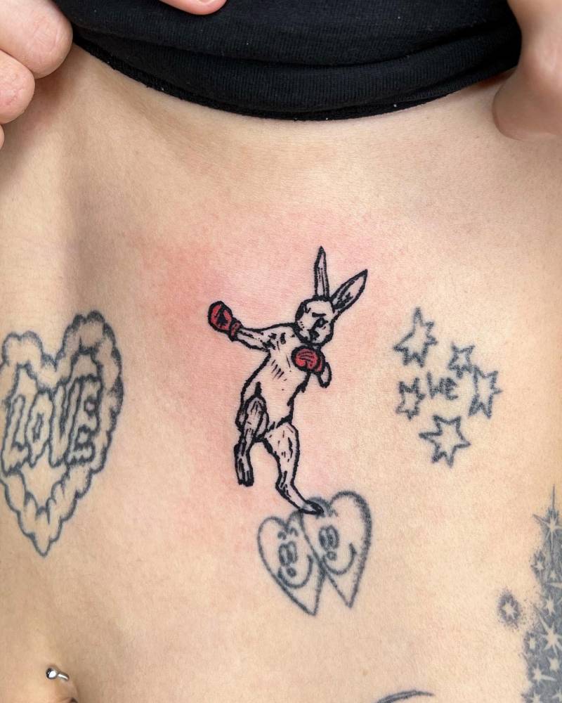 Boxer bunny tattoo located on the rib, engraving style.