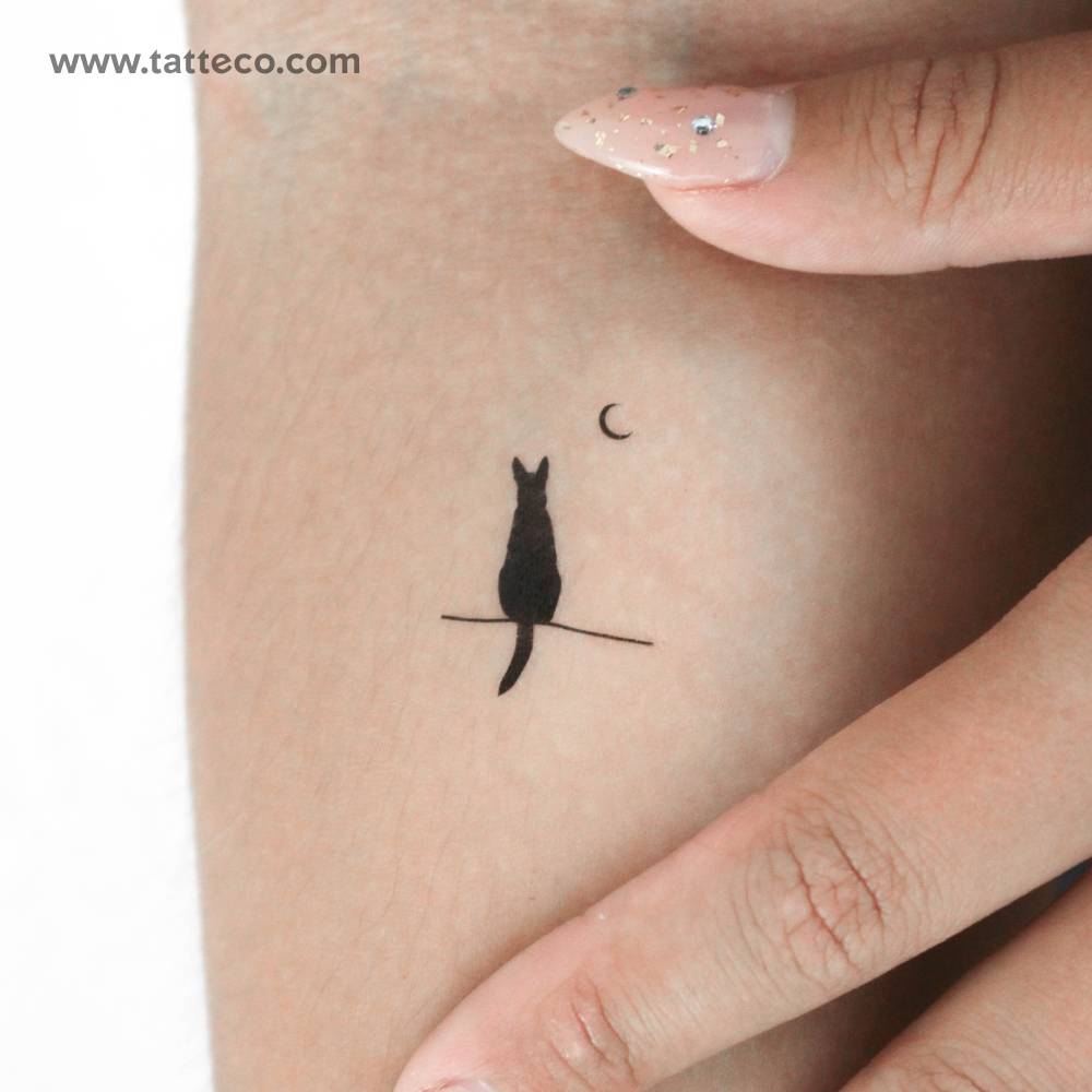 Dog and moon temporary tattoo located on the inner forearm.