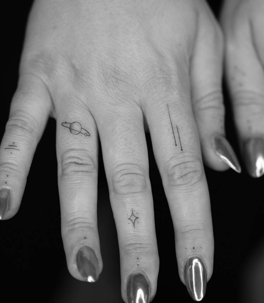 Fine line style finger composition tattoos.