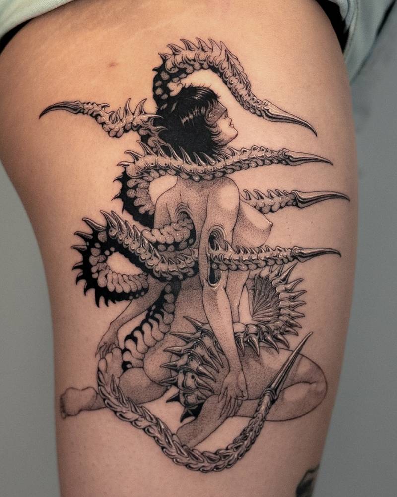 Woman and tentacles tattoo in comic style located on the thigh.