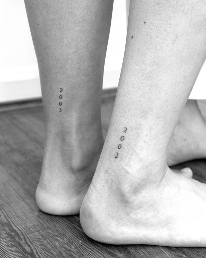 Matching birth year "2003" tattoo for best friends.