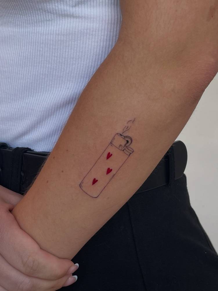Fine line style lighter tattoo located on the forearm.