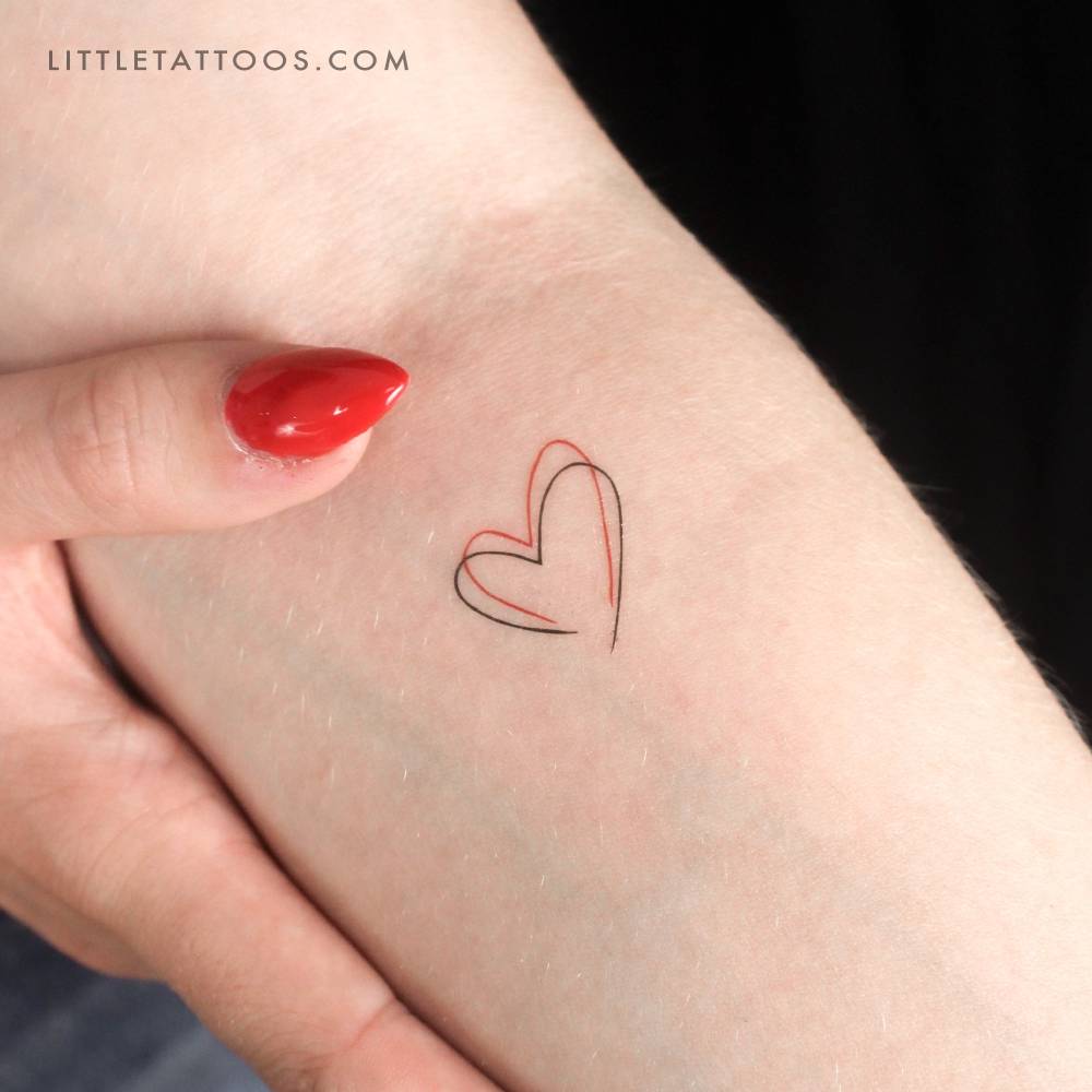Red and black heart temporary tattoo located on the inner forearm.