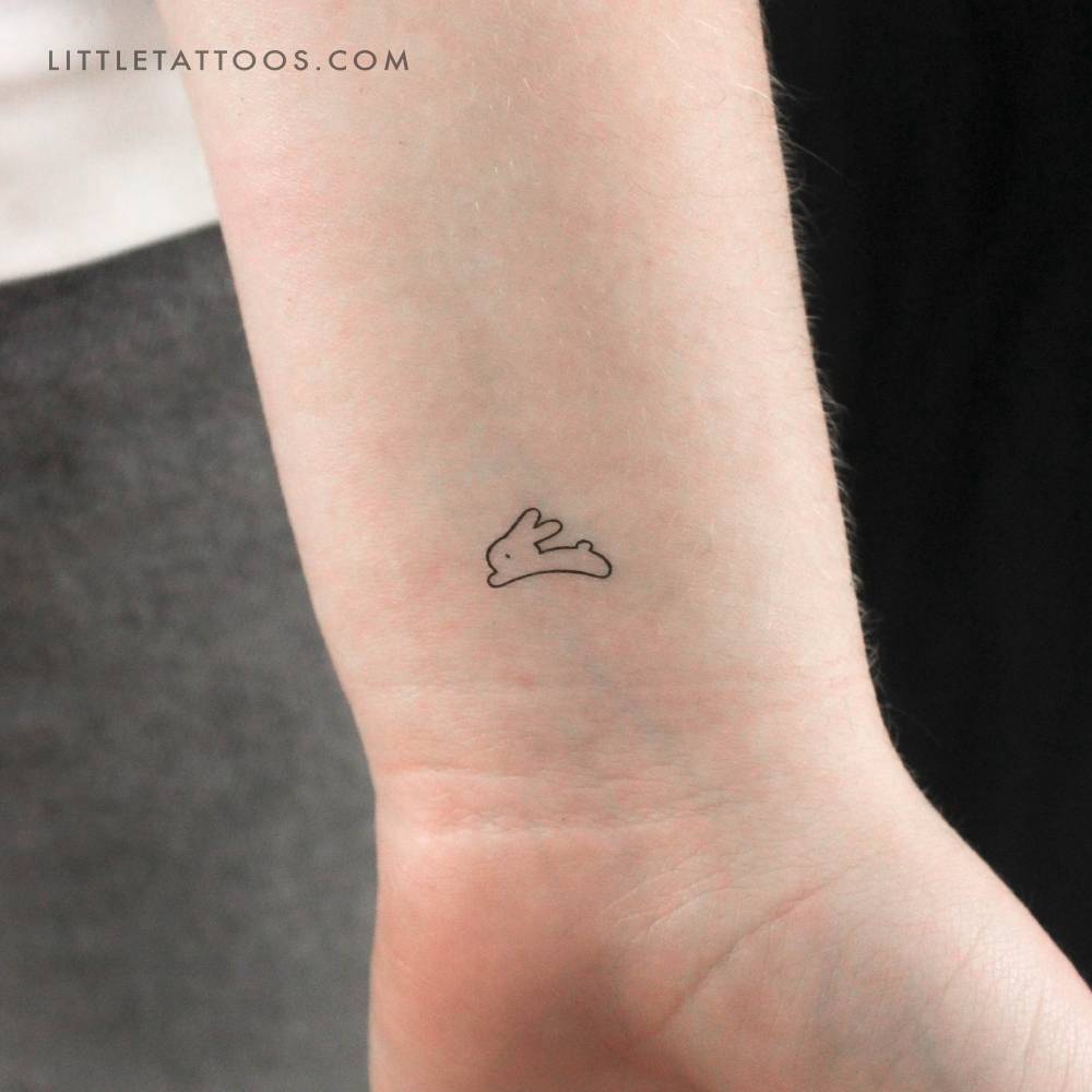 Tiny minimalistic rabbit temporary tattoo located on the wrist.