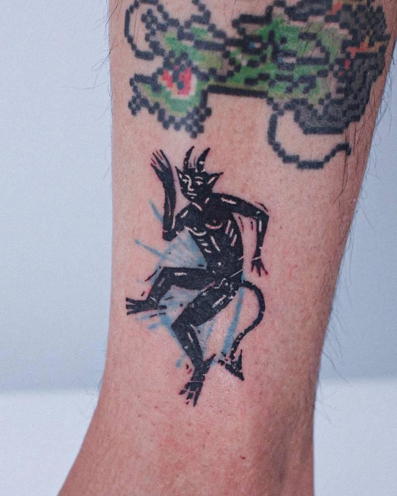 Devil tattoo in pop art style located on the ankle.