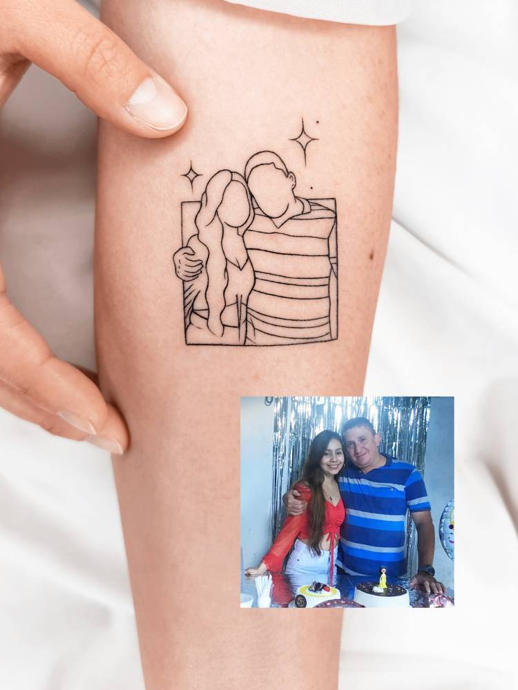 Father and daughter portrait tattoo located on the inner forearm.