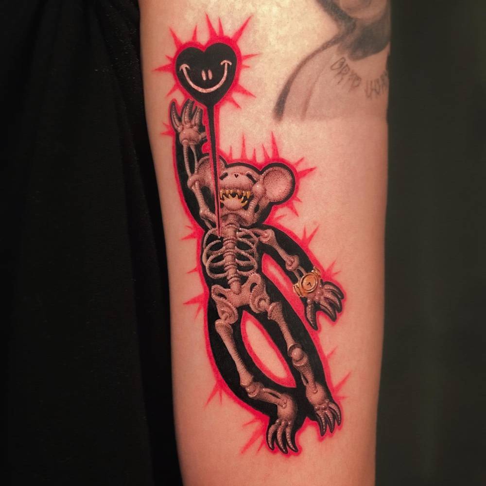 Pop art style x-ray teddy bear tattoo located on the upper arm.