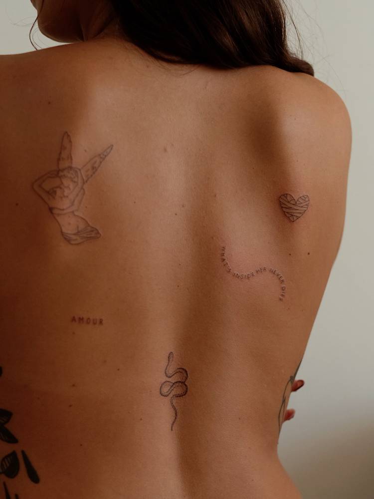 Fine line style back composition tattoos