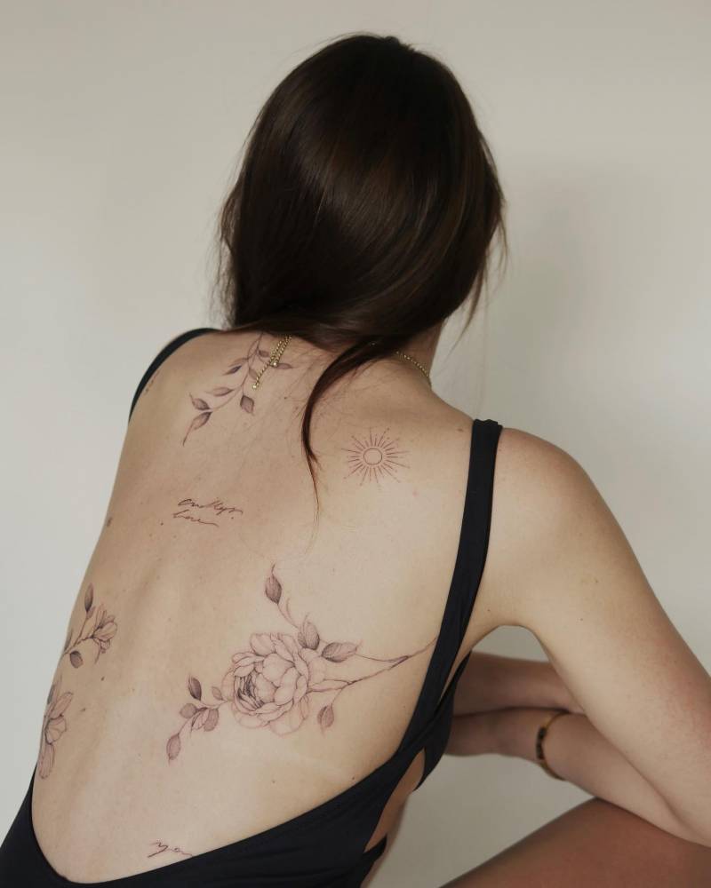 Floral back compostion tattoos.