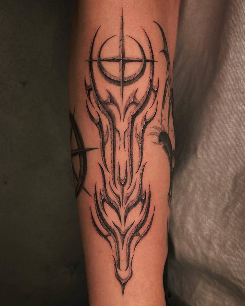 Tribal style design tattooed on the forearm.