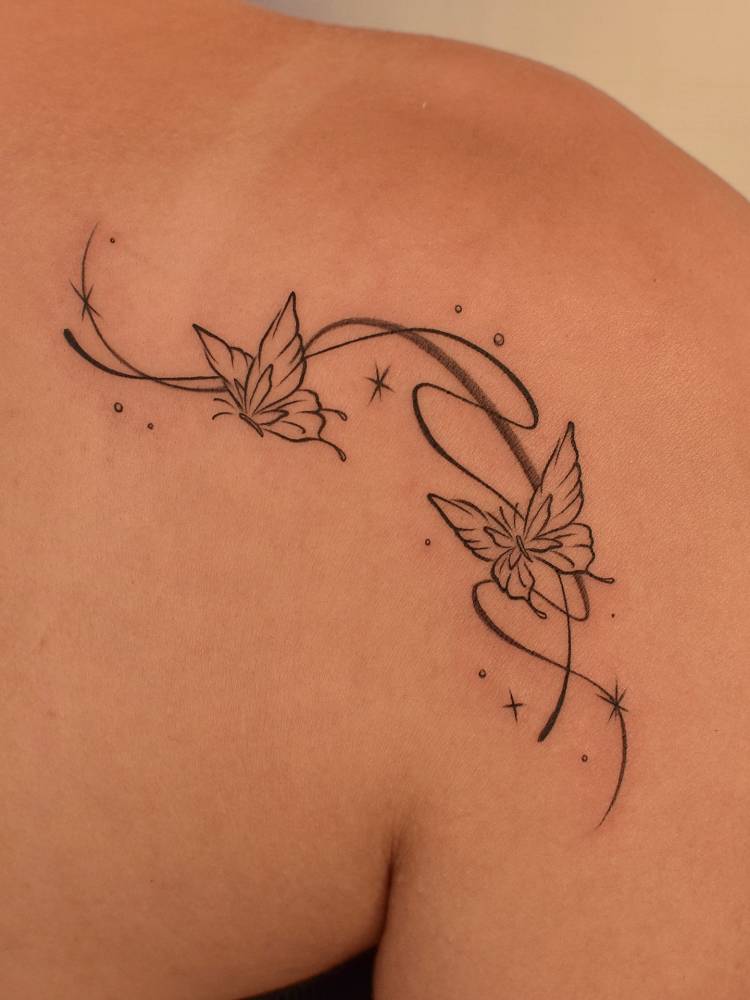 Butterfly couple tattoo located on the shoulder blade.