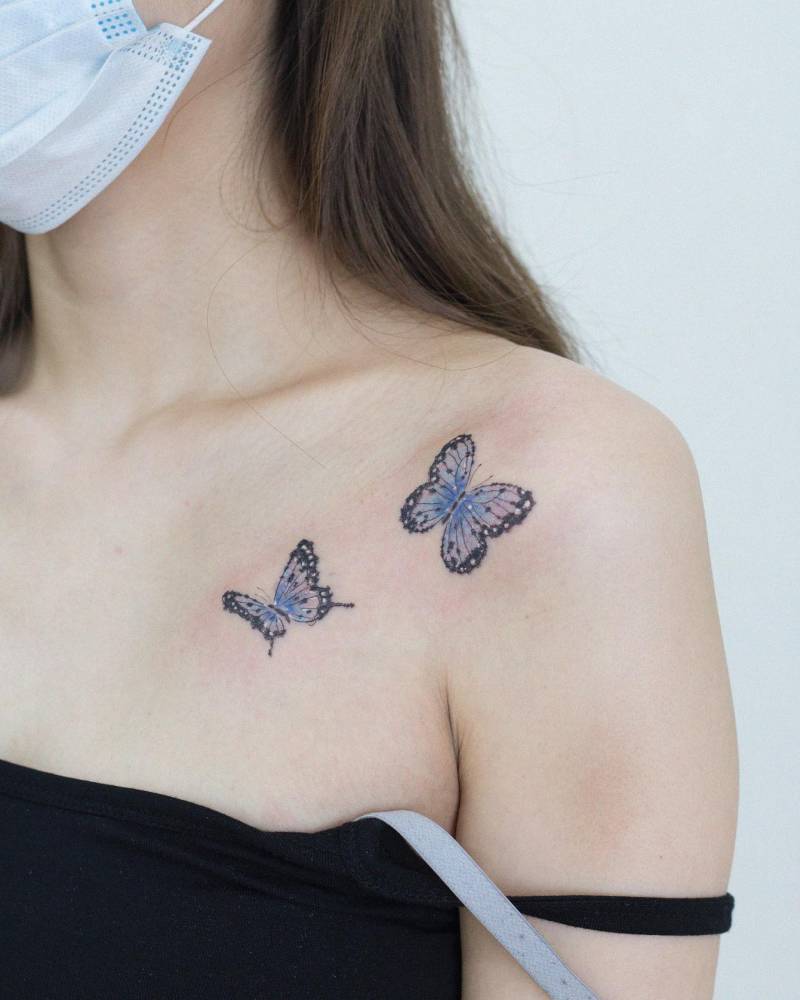 Blue butterfly couple tattoo located on the shoulder.