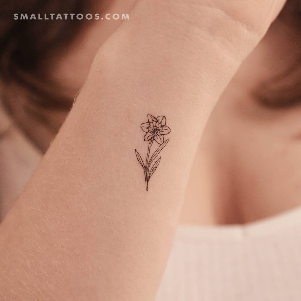 Fine line style narcissus flower temporary tattoo located on the wrist.