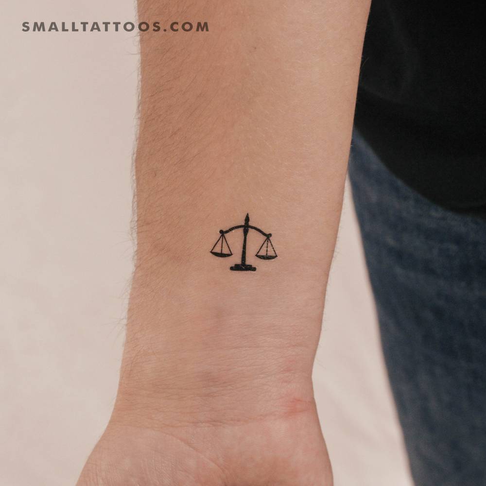 Minimalistic style scale temporary tattoo located on the wrist.