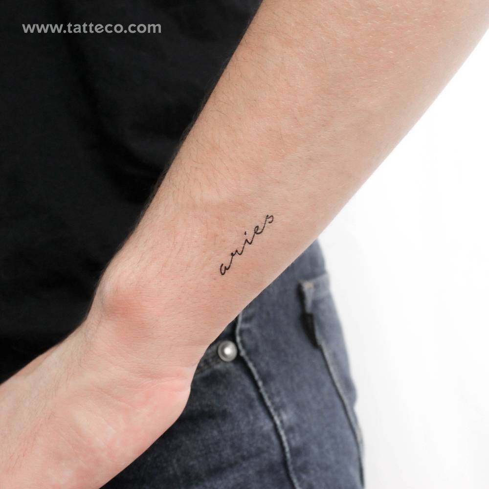 Handwritten font word "Aries" temporary tattoo located on the wrist.