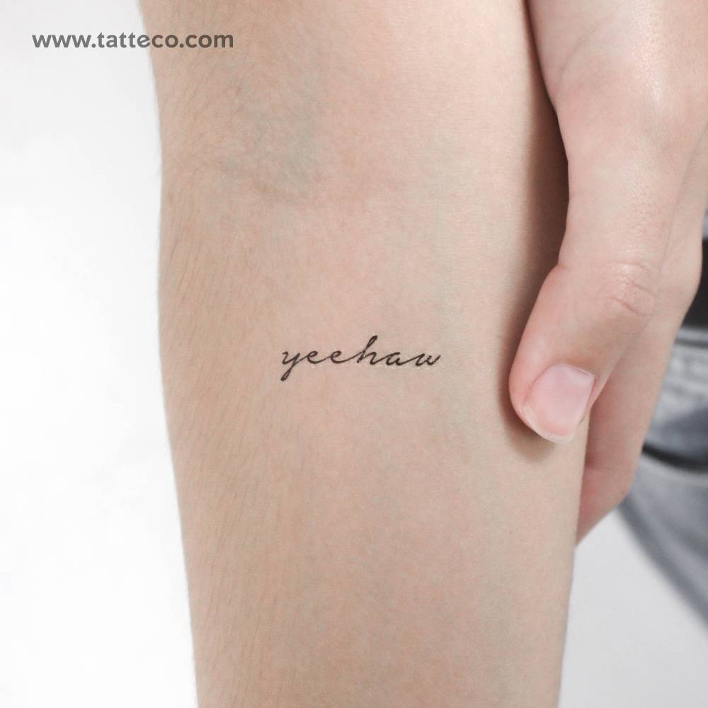 "Yeehaw" temporary lettering tattoo placed on the inner forearm.
