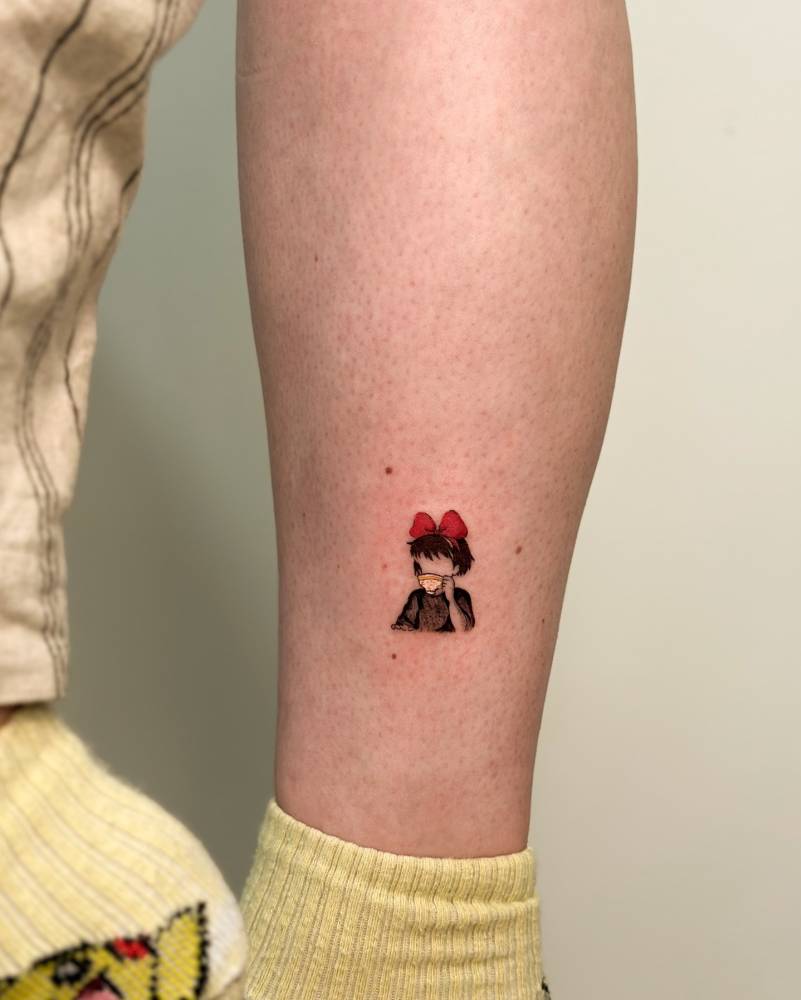 Kiki portrait tattoo in cartoon style done on the shin.