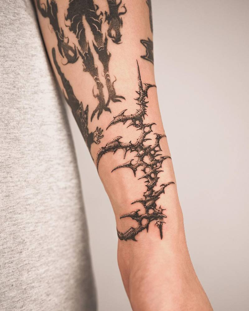 Illustrative style thorns tattoo placed on the wrist.