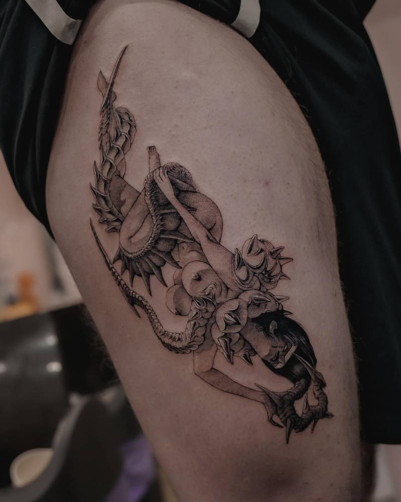 Comic style nude woman tattoo located on the thigh.
