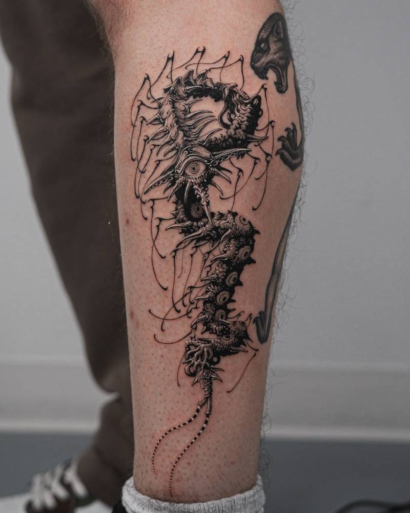 Illustrative style centipede tattoo located on the shin.