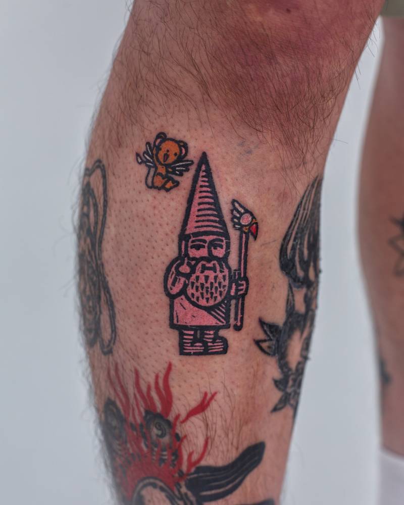 Pop art style gnome tattoo located on the shin.