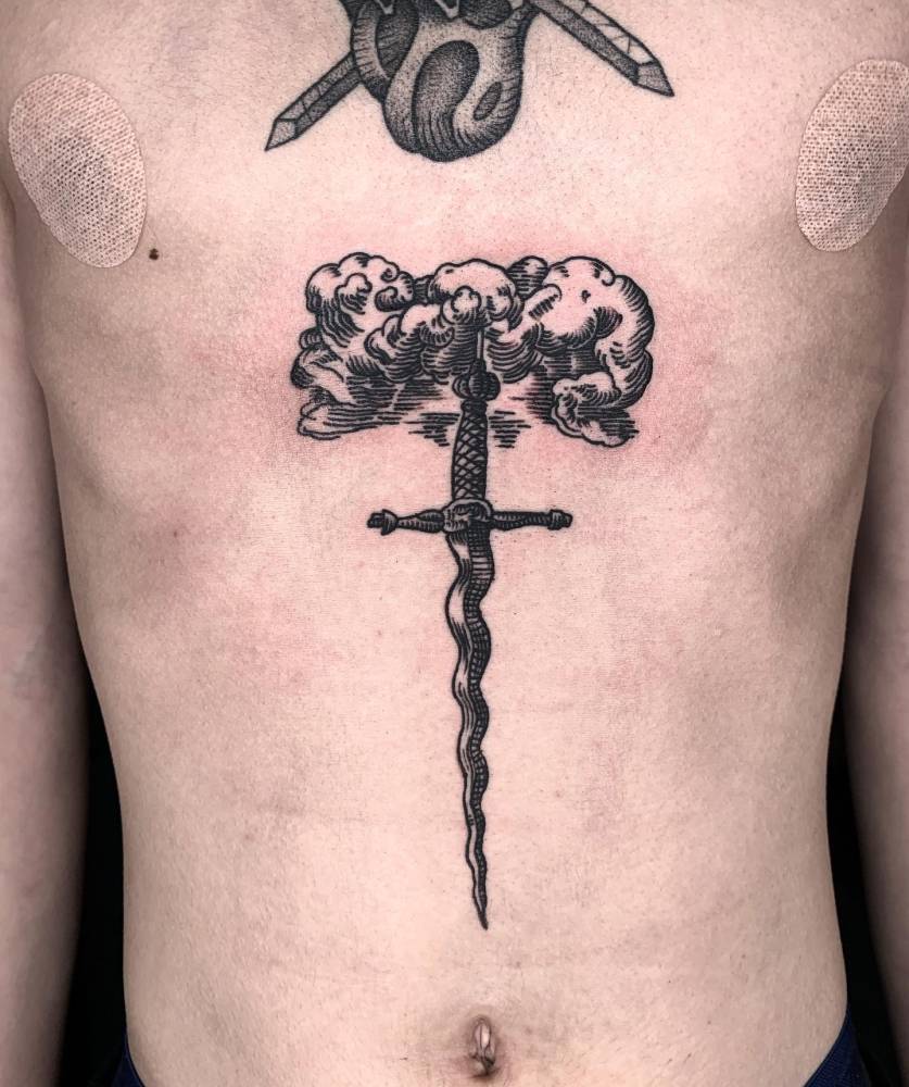 Engraving style sword and cloud tattoo located on the stomach.