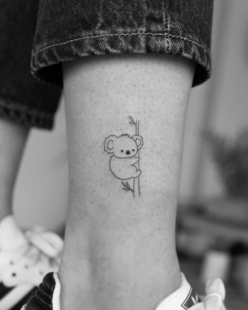 Little koala bear tattoo in fine line style located on the ankle.