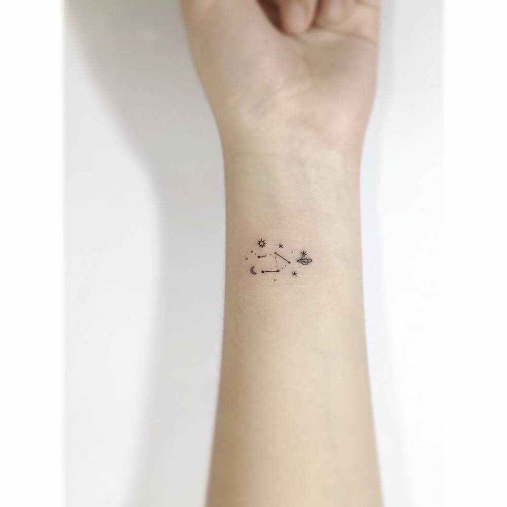 Libra constellation tattoo in minimalistic style done on the wrist.