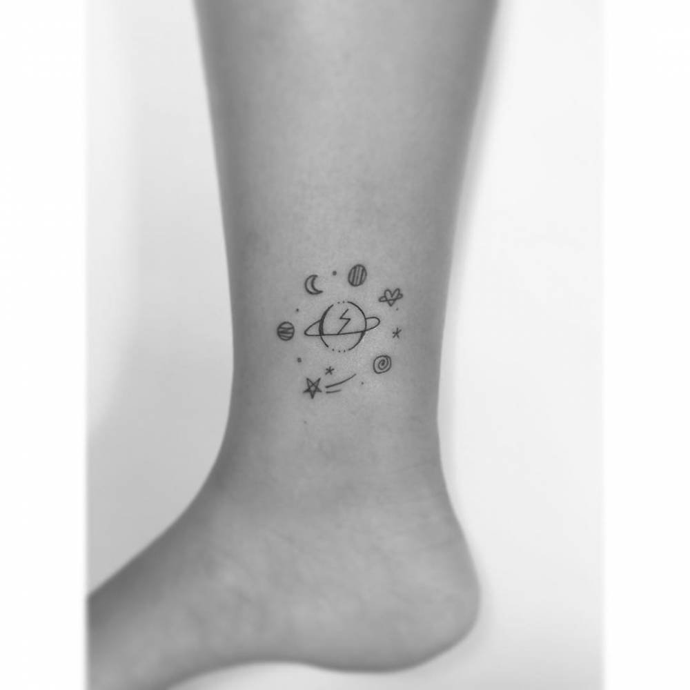 Universe tattoo in minimalistic style placed on the ankle.