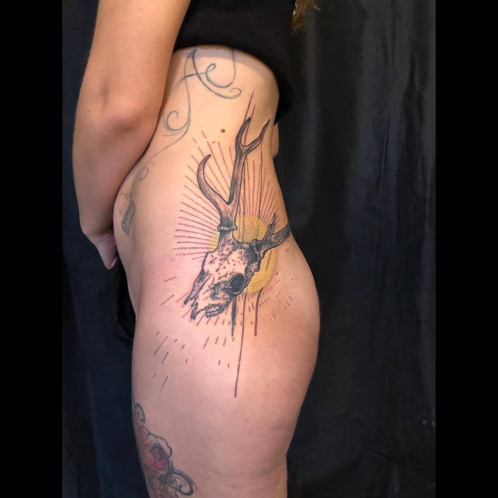 Huge deer skull tattoo in engraving style.