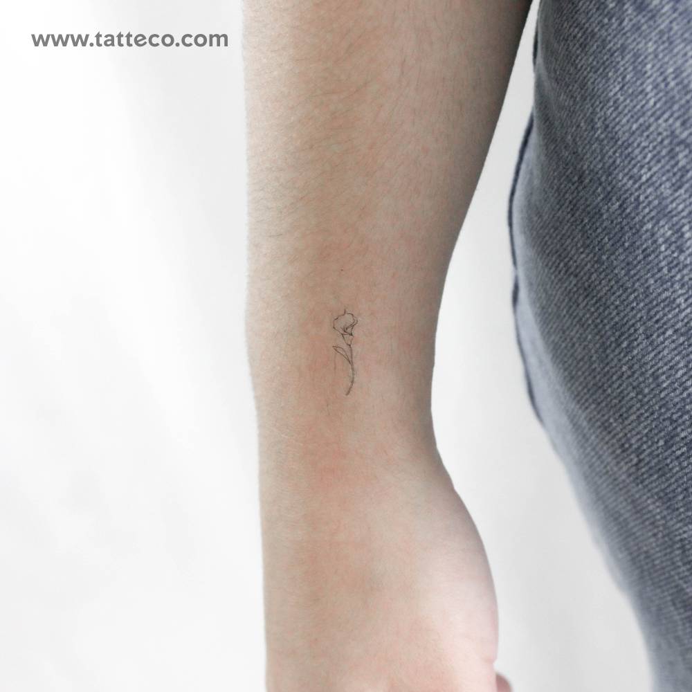 Little fine line style calla temporary tattoo placed on the wrist.
