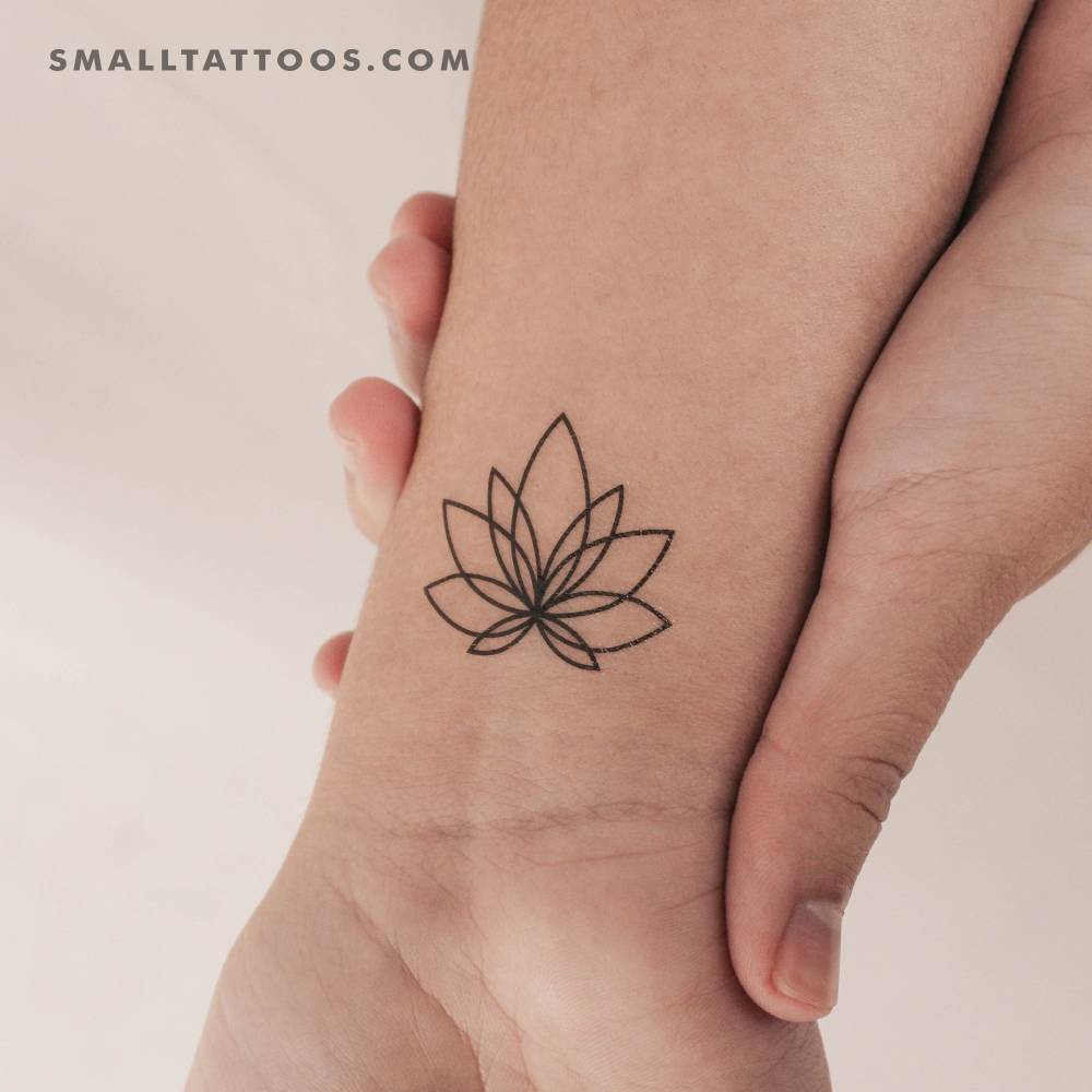 Line art style lotus temporary tattoo located on the wrist.