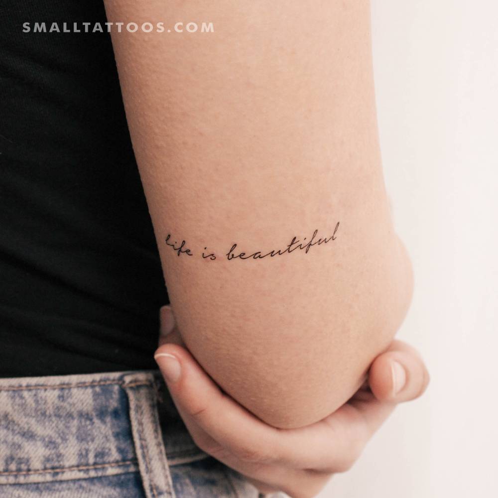 Handwritten font "life is beautiful" temporary tattoo located on the tricep.
