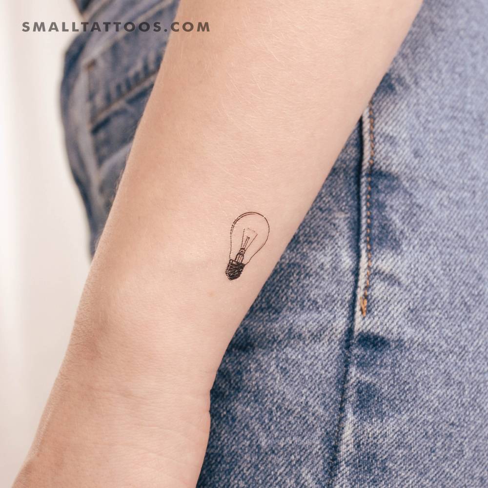 Shining light bulb temporary tattoo placed on the wrist.