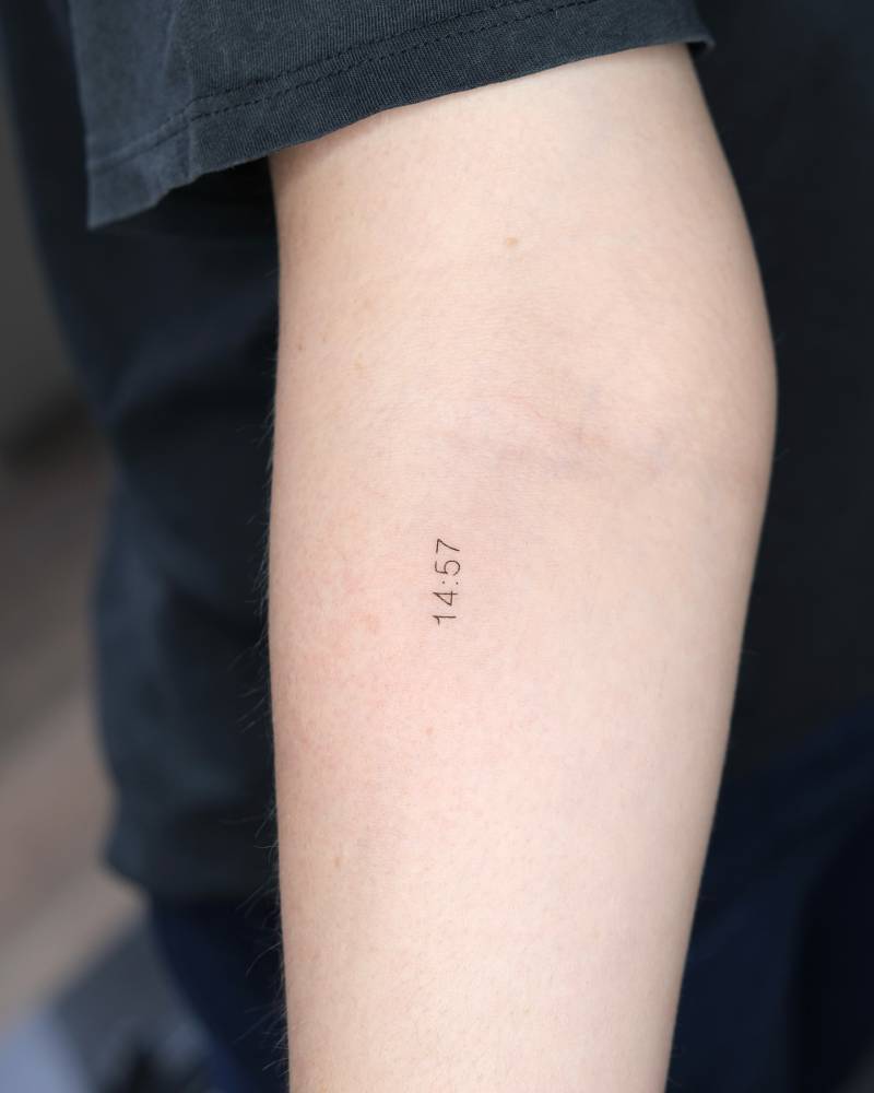 Hour tattoo located on the inner forearm, done in minimalistic style.