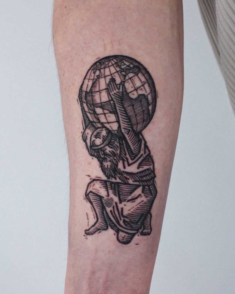 Engraving style Atlas tattoo located on the inner forearm.