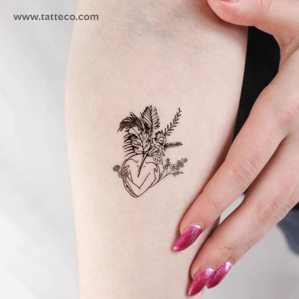 Illustrative style flower head woman temporary tattoo located on the inner forearm.