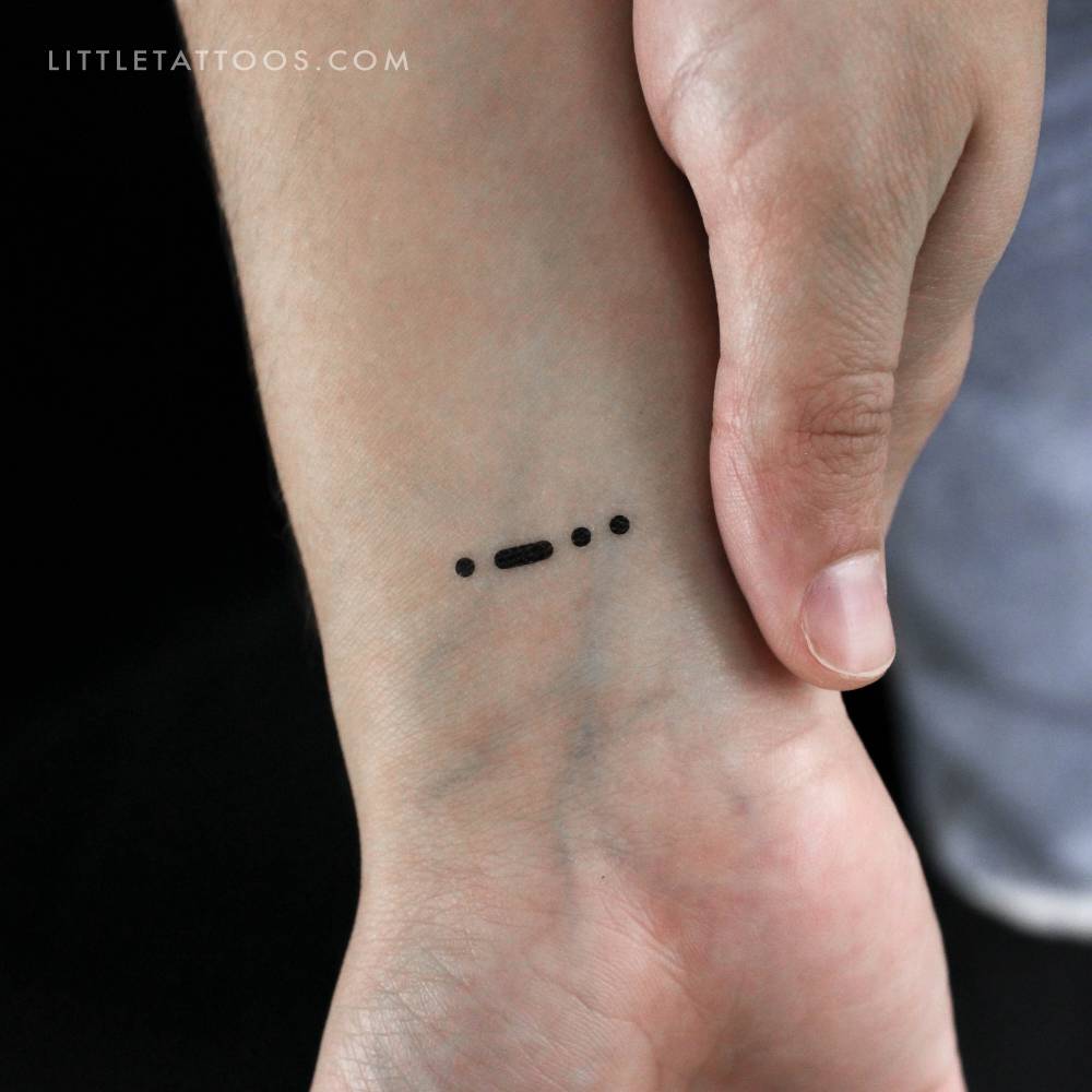 Minimalistic style Morse Code L temporary tattoo located on the wrist.