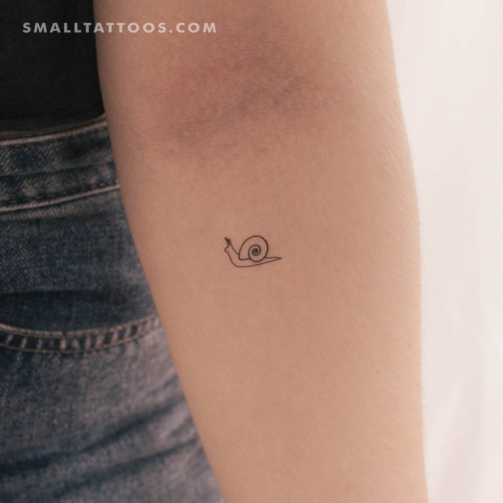Minimalist snail temporary tattoo located on the inner forearm.