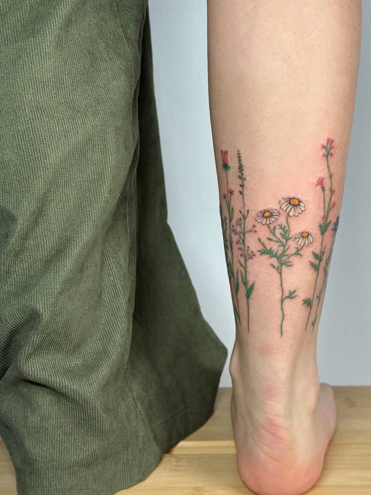 Flower collection tattoo located on the achilles.