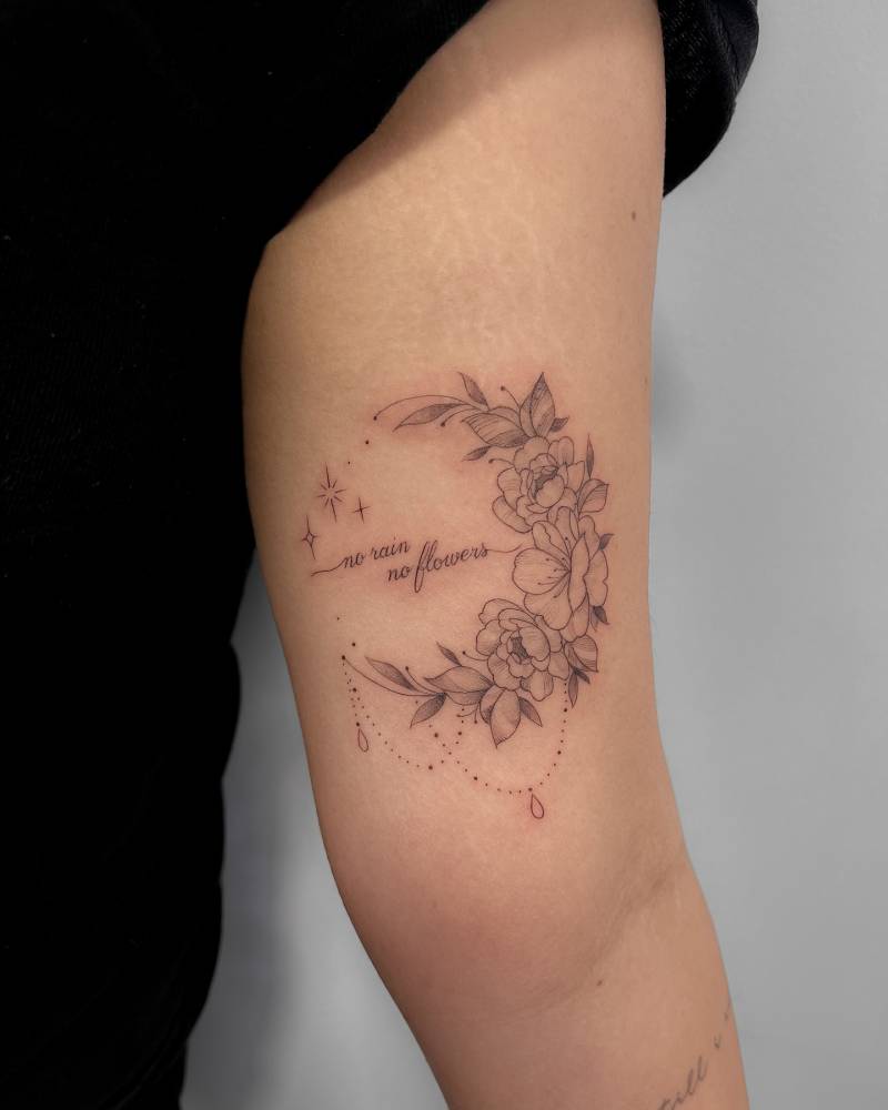 Flower moon tattoo in illustrative style placed on the inner arm.