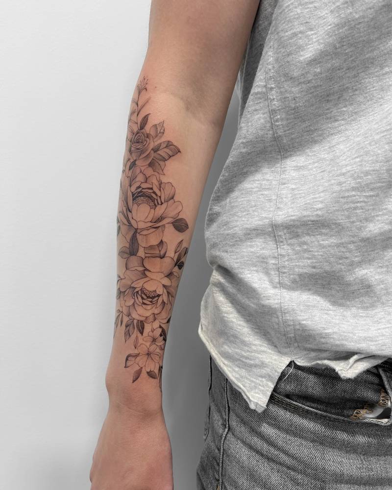 Peonies tattoo in illustrative style located on the forearm.