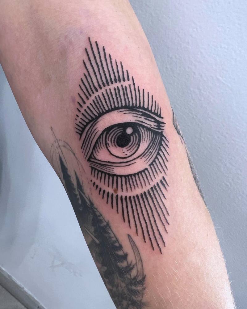 Eye tattoo in engraving style located on the forearm.