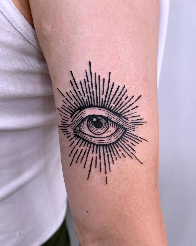 Eye tattoo located on the tricep, done in engraving style.