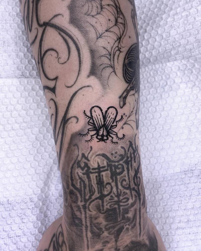 Fly gap filler tattoo in engraving style located on the forearm.