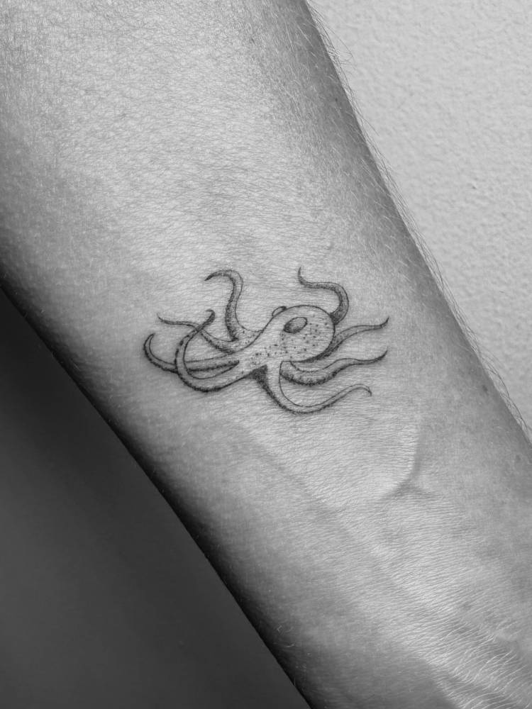 Illustrative style octopus tattoo located on the wrist.