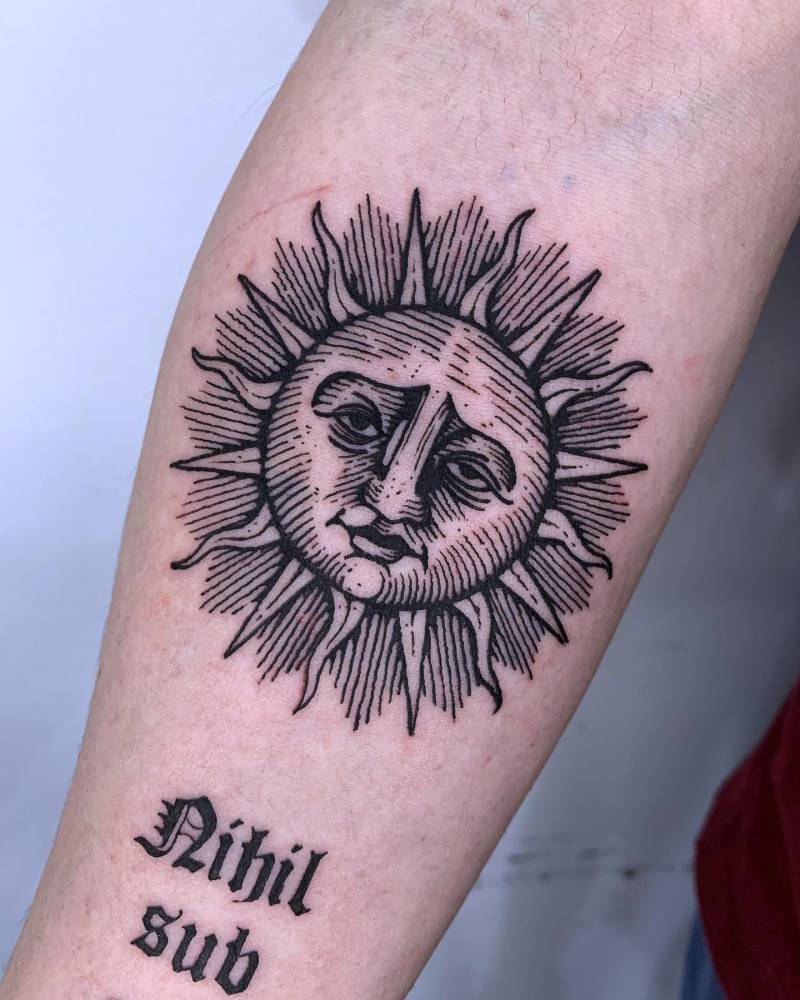 Inti sun tattoo located on the inner forearm, blackwork style.