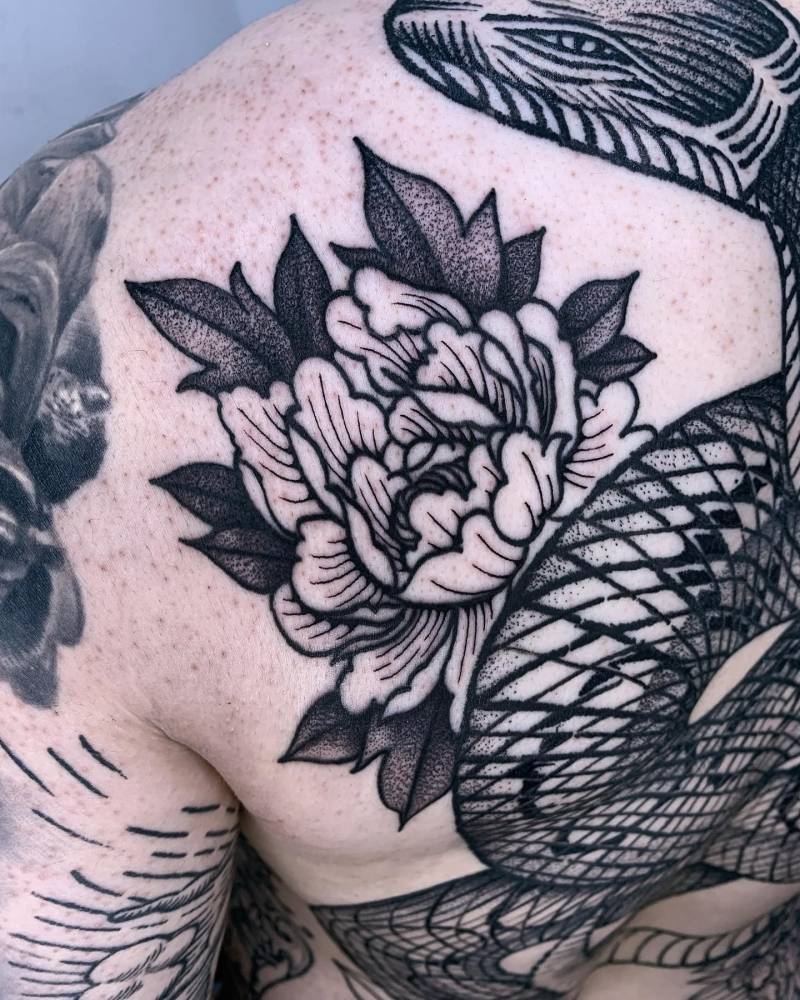 Blackwork style peony tattoo located on the shoulder blade.