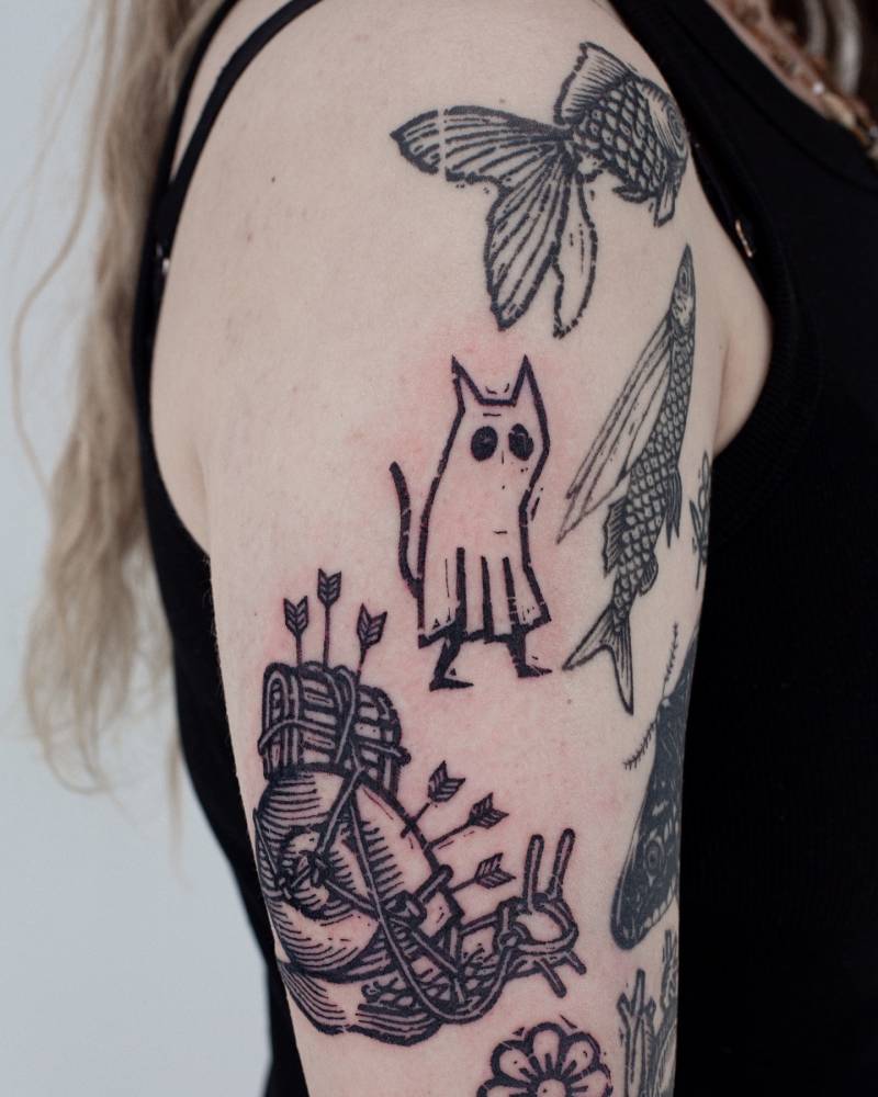 Ghost cat tattoo located on the upper arm, blackwork style.