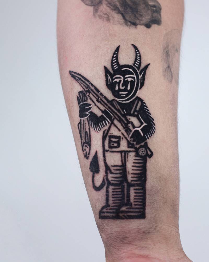 Devil tattoo located on the wrist, pop art style.